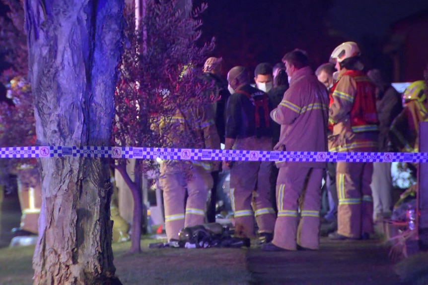 Firefighters outside a house.