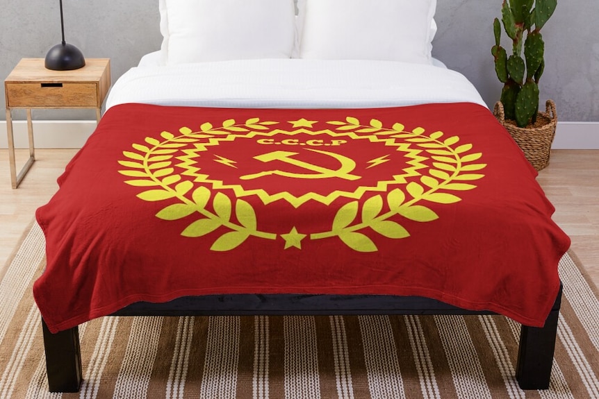 A red and gold hammer-and-sickle throw blanket.
