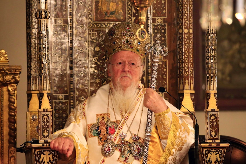 Patriarch Bartholomew I sits on a throne