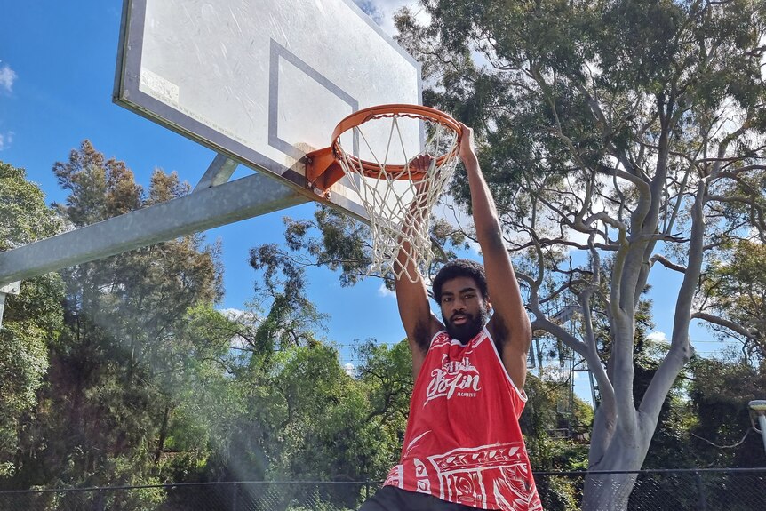 Buru hanging off a basketball hoop