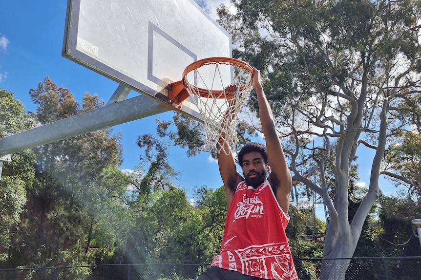 Buru hanging off a basketball hoop