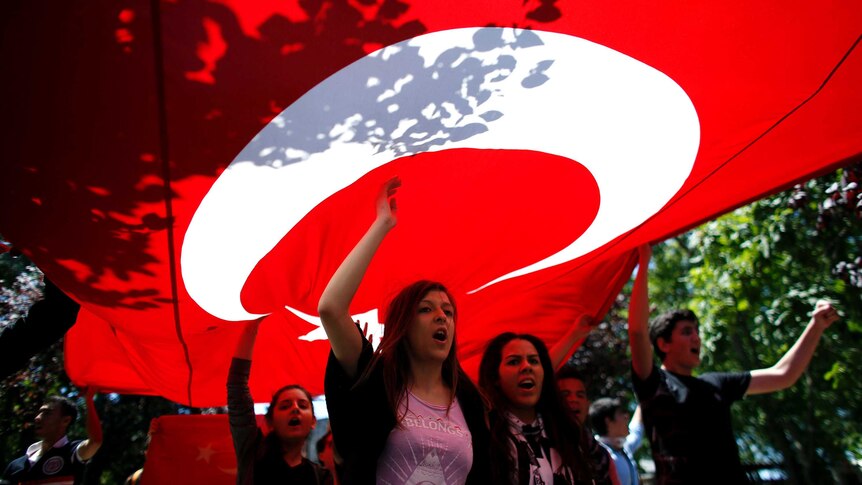 Protesters carry Turkish flag during protests in Istanbul