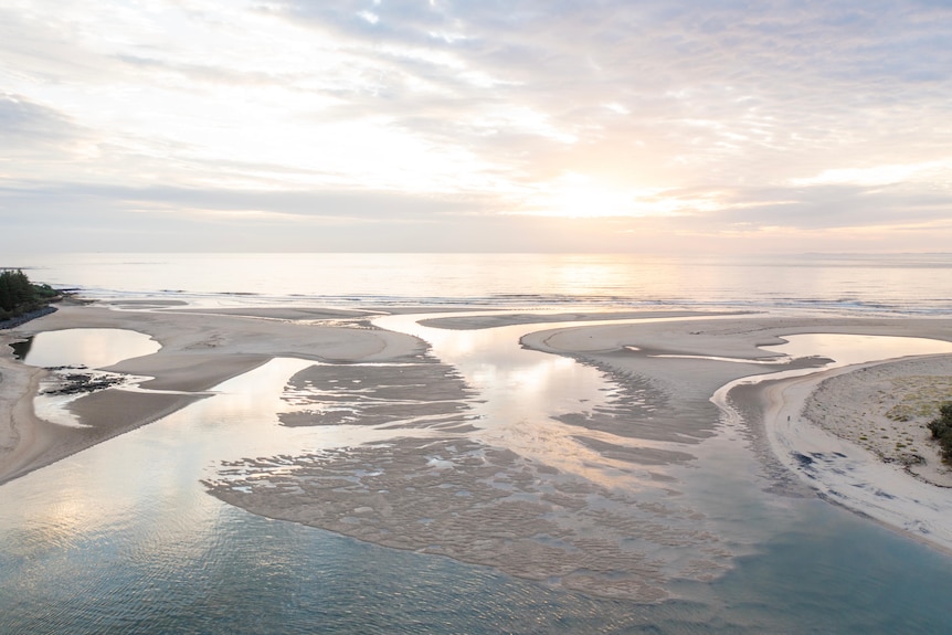 An aerial view of an island with a channel running through it.