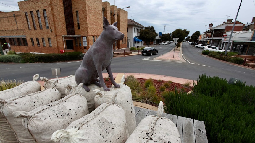 Statue of a dog sitting on sacks