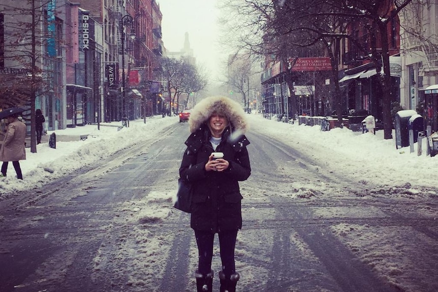 Louise Robertson stands in the middle of an empty snow-lined New York street