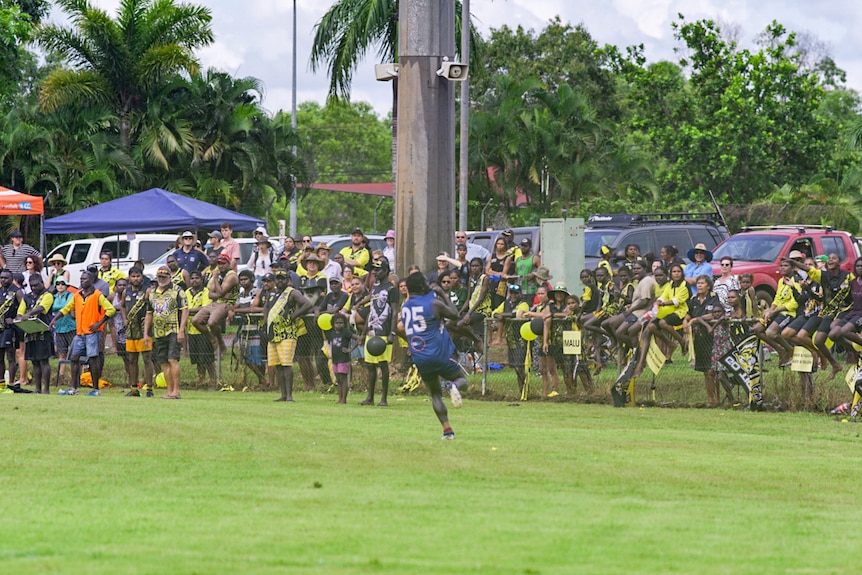 A Bulldogs player celebrates in front of Imalu's fans.