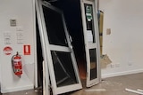 photo of front door smashed in at a premises