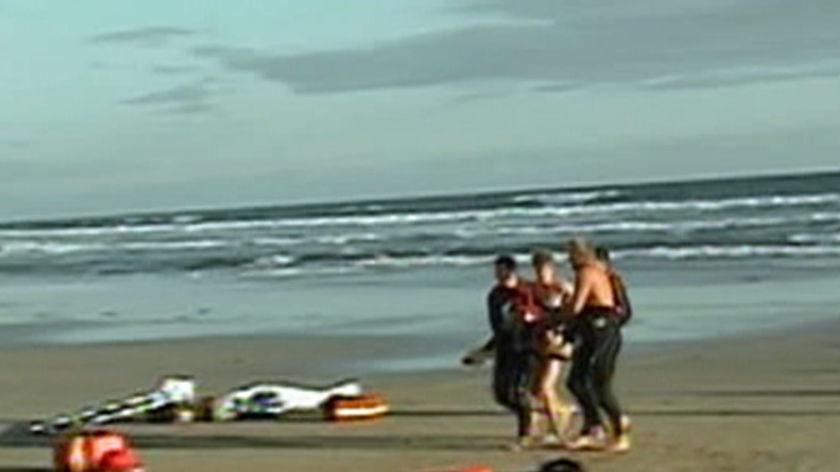 Rescuers at Hutt Gully beach near Anglesea where two people drowned.