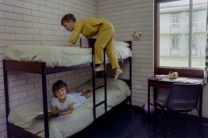 Two children on bunk beds in bedroom
