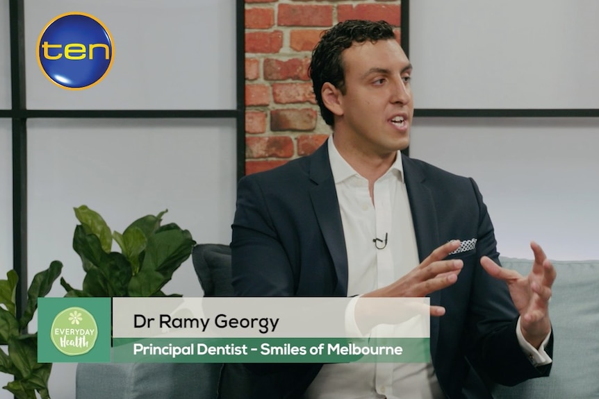 Smiles of Melbourne dentist Ramy Georgy sitting on a couch and talking in a Channel 10 appearance.