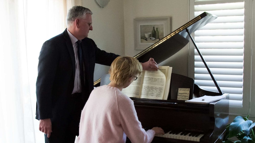 Robert Titterton turning pages for Maria Raspopova as she plays at the piano