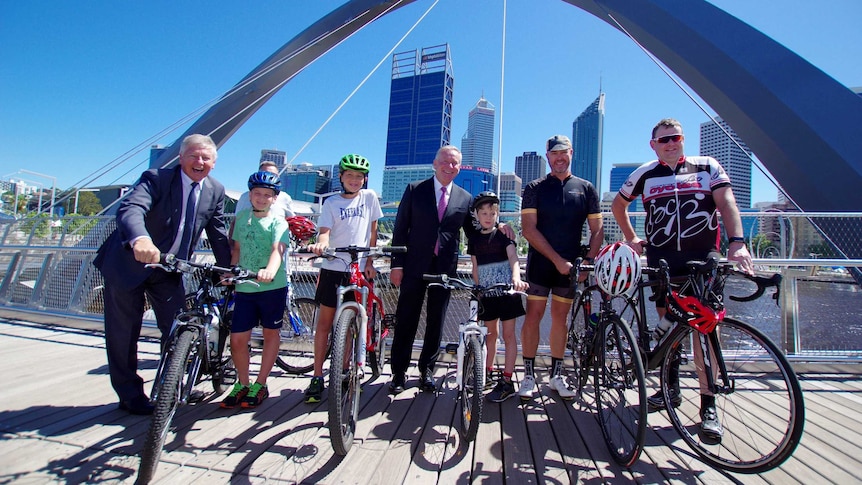Premier Colin Barnett and Transport Minister Bill Marmion stand with a group of cyclists.