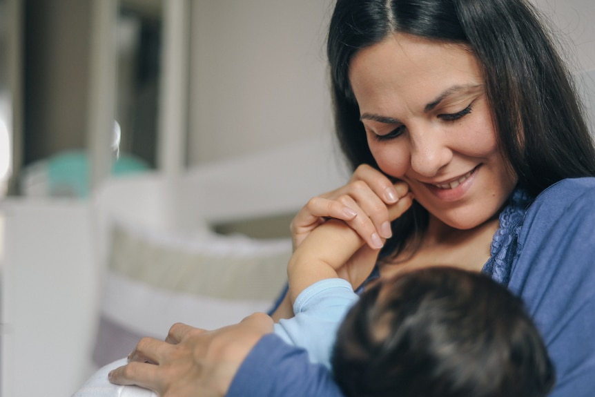 Mother breastfeeding her newborn baby.