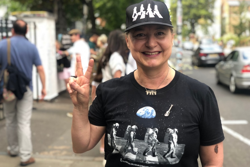 A woman dressed in Beatles memorabilia