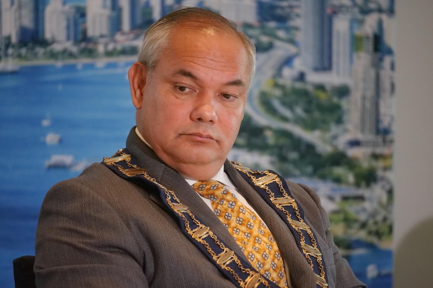 Man wearing suit and mayoral chain around his neck. 