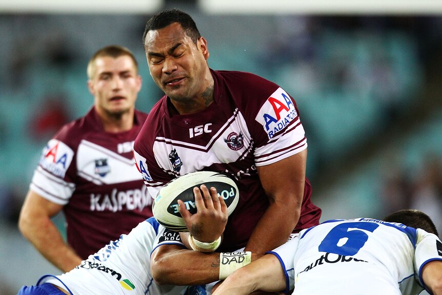 Physical encounter ... Tony Williams is met by the Bulldogs defence
