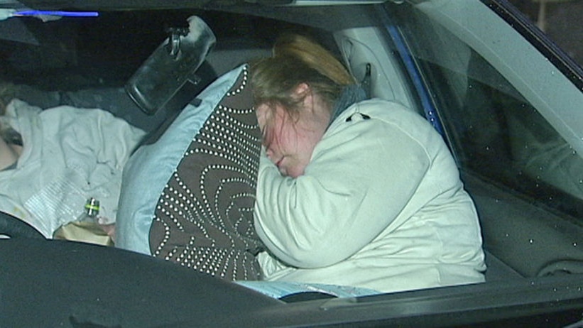 A woman sleeps in her car to highlight the plight of Australia's 46,000 homeless females.