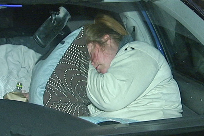 A woman sleeps in her car to highlight the plight of Australia's 46,000 homeless females.