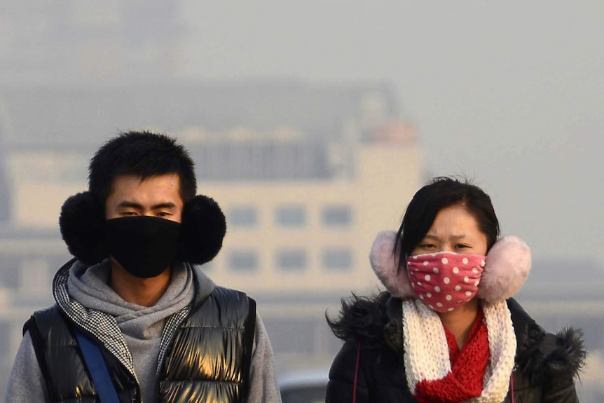 People wear face masks in Beijing