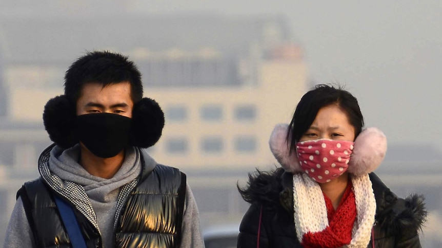 People wear face masks in Beijing