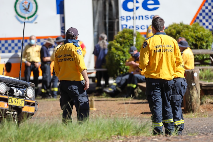 men standing in front of a police van