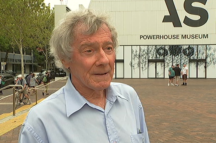 A man standing in front of a Sydney muesuem.