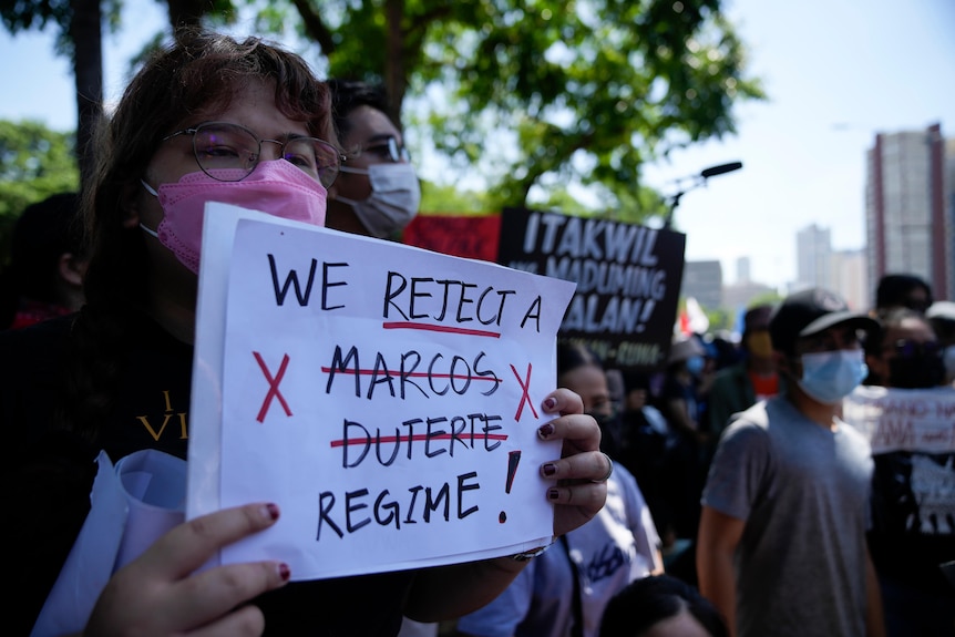 A protester hold slogans during a rally against presidential frontrunner