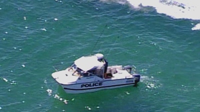 Police search for the victim of the shark attack off Adelaide.
