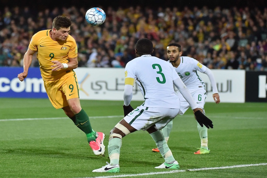 Socceroos' Tomi Juric heads home his second goal against Saudi Arabia
