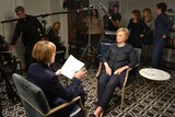 Hillary Clinton is being interviewed by Sarah Ferguson as a room full of producers and minders looks on