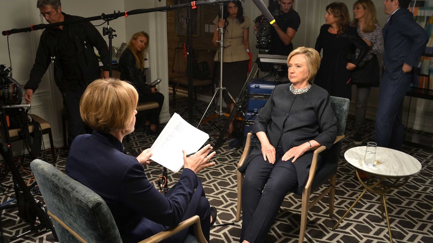 Hillary Clinton is being interviewed by Sarah Ferguson as a room full of producers and minders looks on