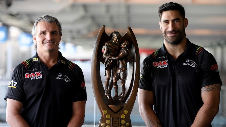 Penrith Panthers coach Ivan Cleary and James Tamou stand with the Provan-Summons Trophy ahead of the NRL grand final.