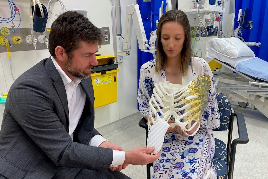 Dr Michael Wagels with patient Caitlin Rutherford-Heard in a hospital clinic.