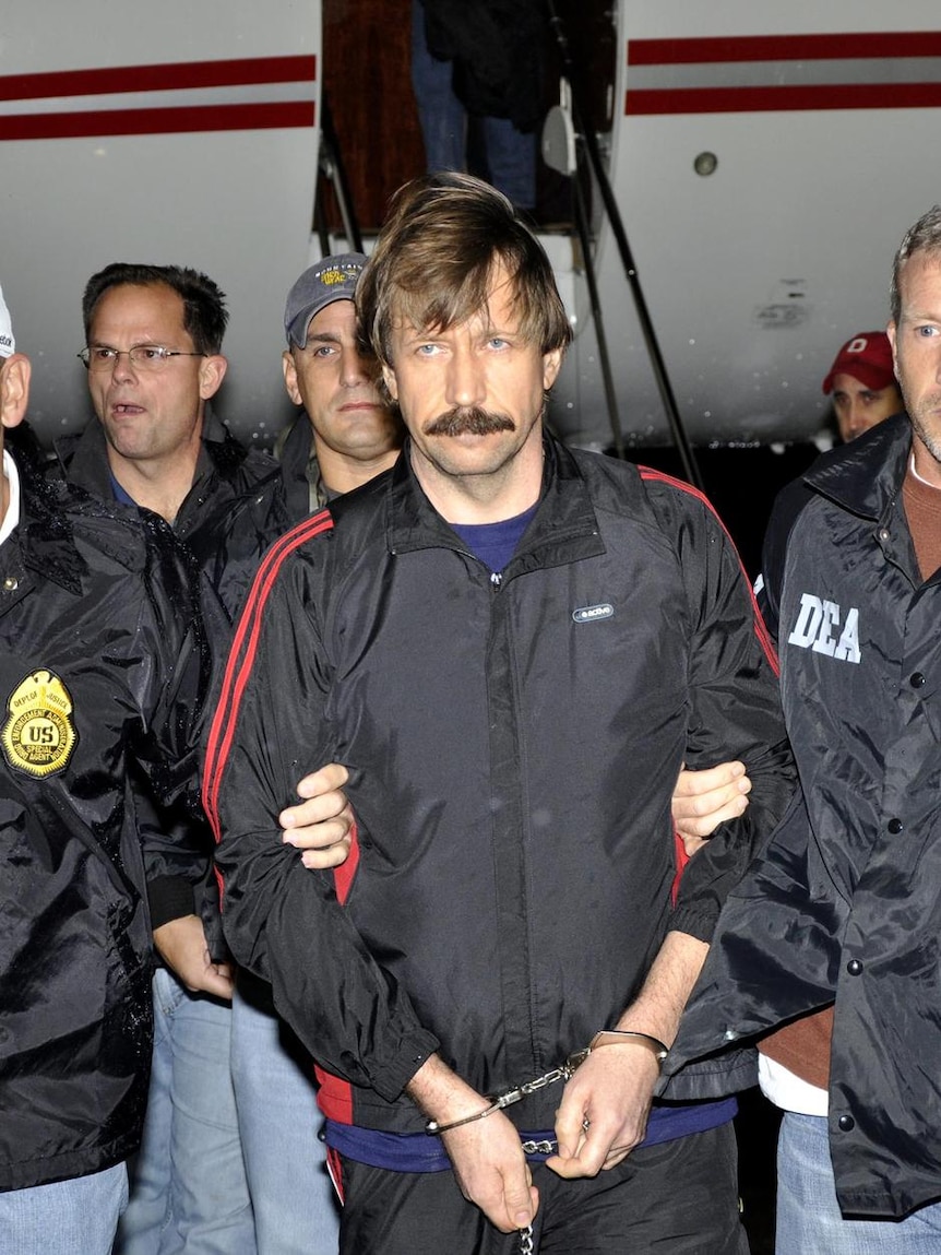 Viktor Bout, centre, is escorted by DEA officers