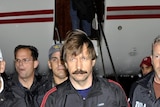 Viktor Bout, centre, is escorted by DEA officers