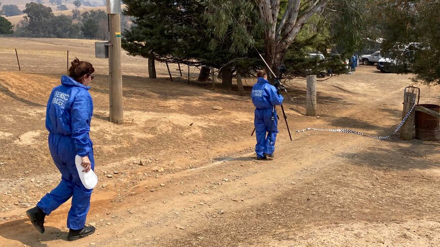 Forensics teams outside the property's gate.