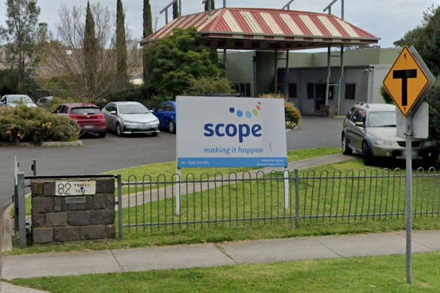 A street view of a disability service centre with a large carpark out front on a grey day.