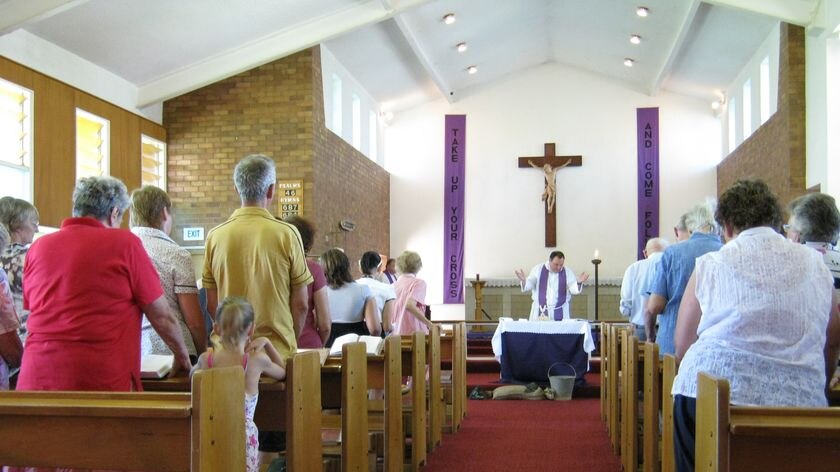 Anglican Priest Charlie Murry addresses the congregation in Charleville after floods