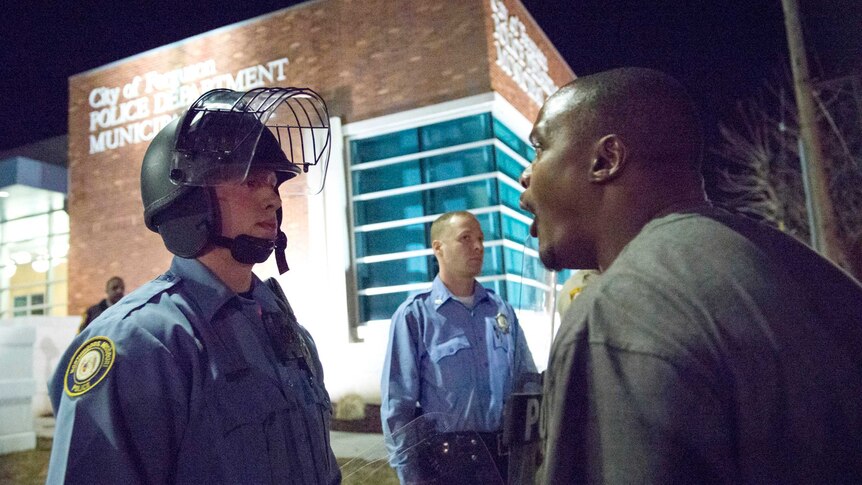 A protester confronts a police officer in Ferguson