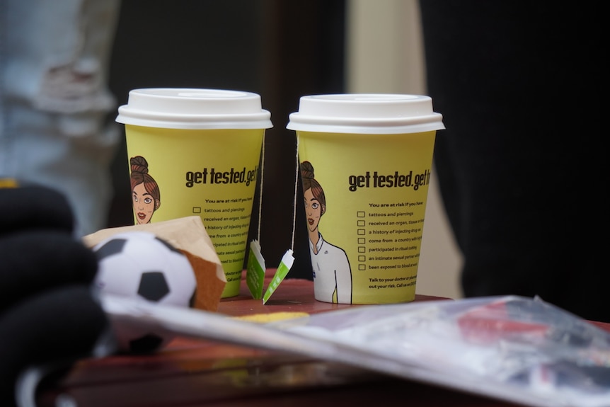 Cups of tea in yellow takeaway containers