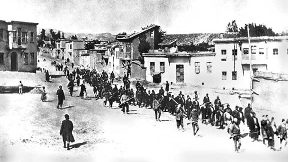 Armenians are marched to a prison by armed Turkish soldiers