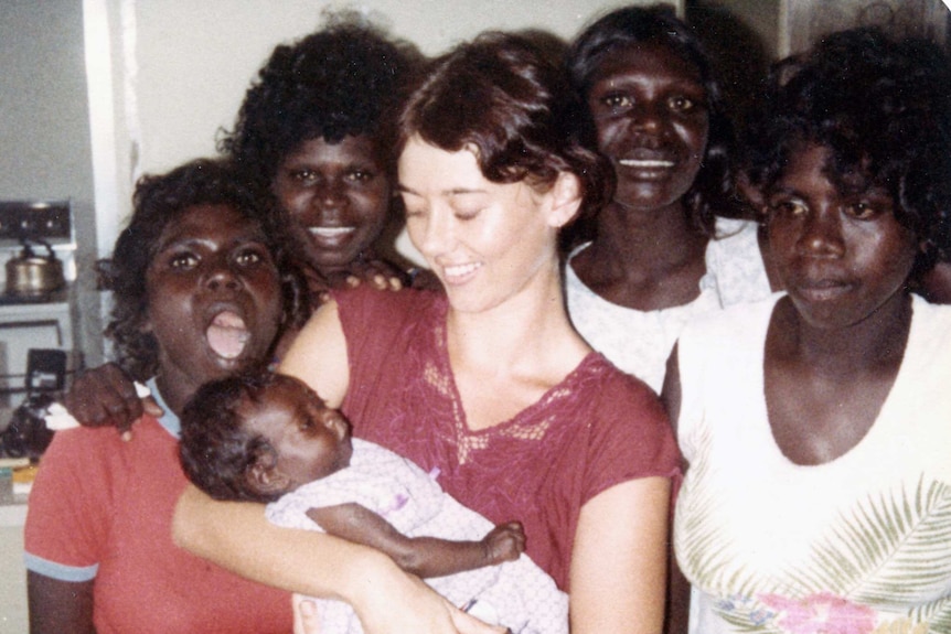 Mickey Dewar with her students and a baby at Millingimbi