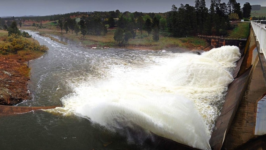 Water flows from Scrivener Dam after heavy overnight rain.