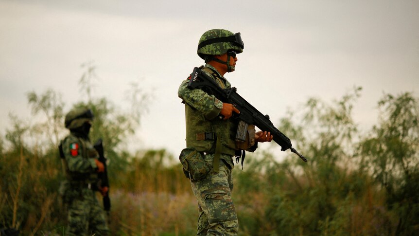 Members of Mexico's army partol a cartel crime scene