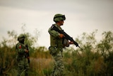 Members of Mexico's army partol a cartel crime scene