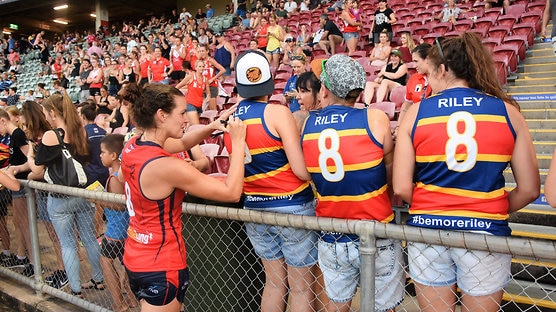 Sally Riley signs autographs after a trial game in Darwin