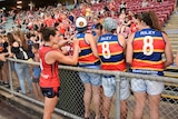 Sally Riley signs autographs after a trial game in Darwin