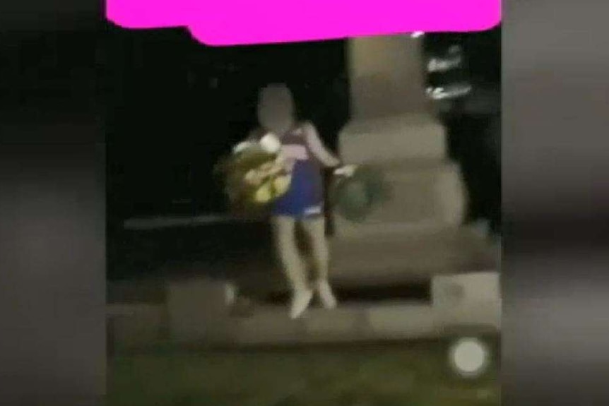 A still from a Snapchat video filmed at Box Hill Gardens as young people steal wreaths from an Anzac memorial.