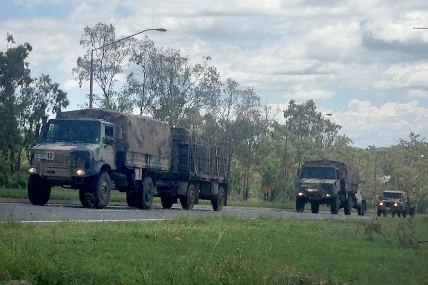 A convoy of Australian Army vehicles makes its way towards Rockhampton to help clean up the cyclone-ravaged region