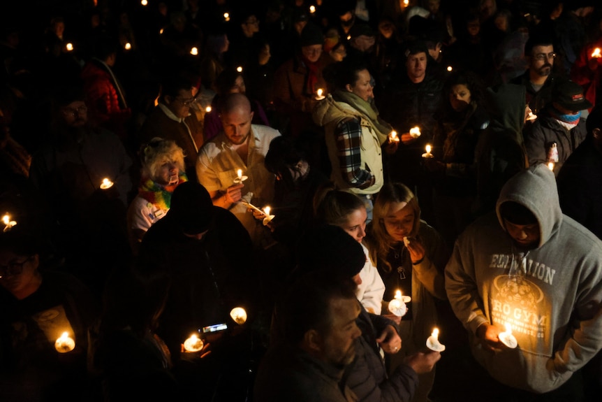 People attend a vigil after a mass shooting at the Club Q gay nightclub.
